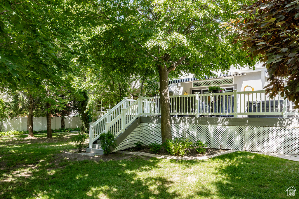 View of yard with a deck and stairs