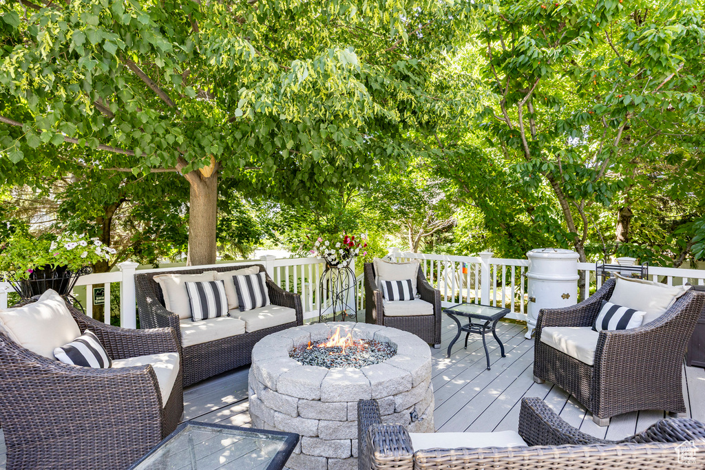 Wooden terrace featuring an outdoor living space with a fire pit