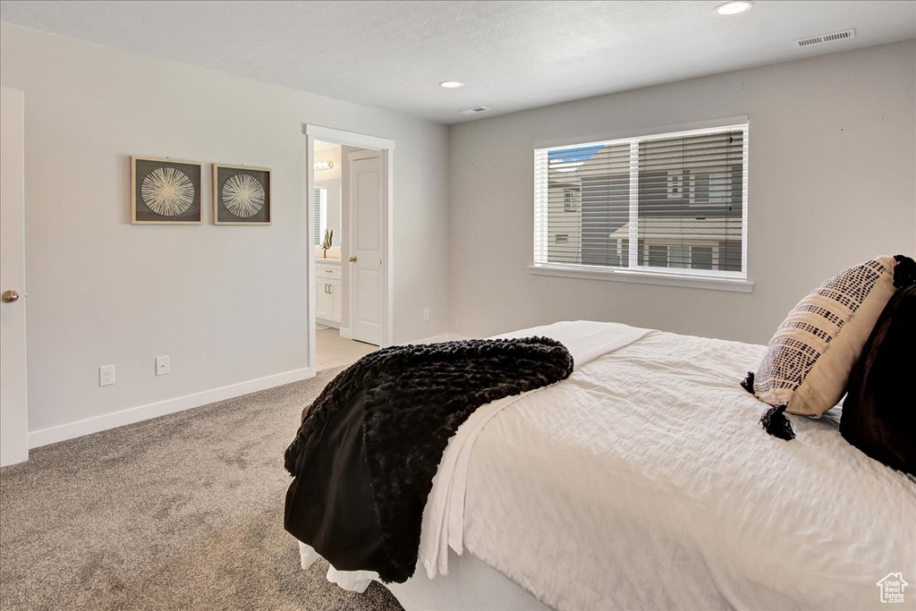 Bedroom with carpet flooring, recessed lighting, and ensuite bath