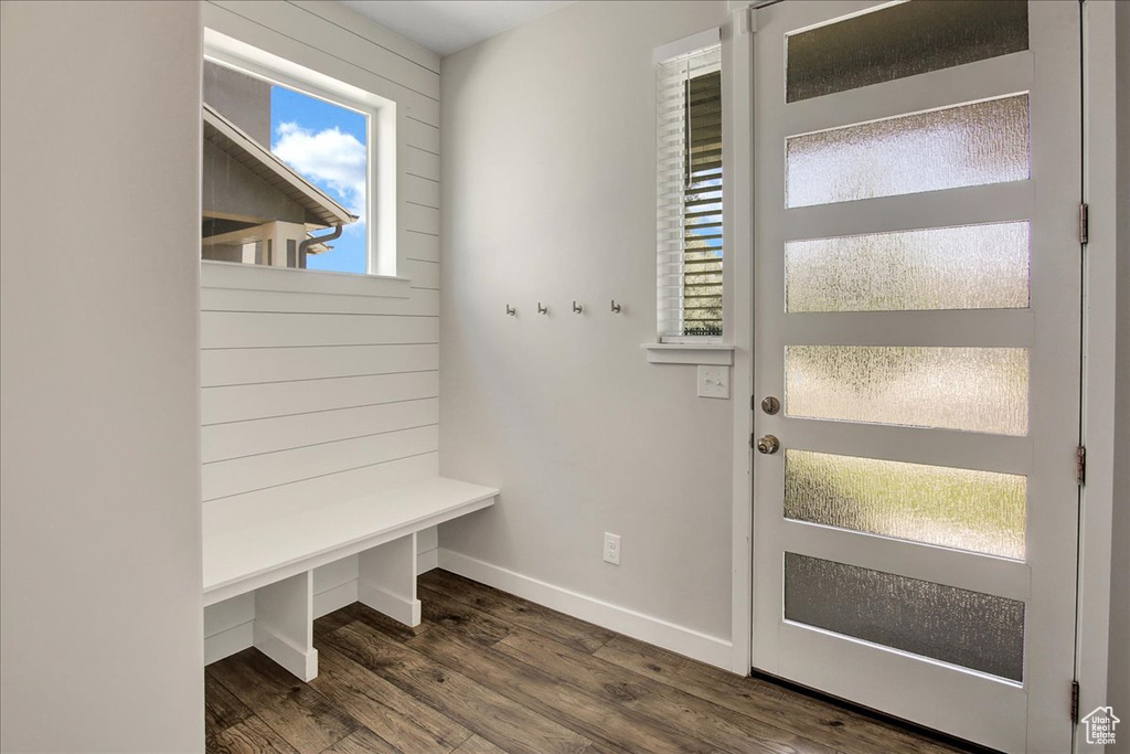 Mudroom featuring dark wood finished floors and baseboards