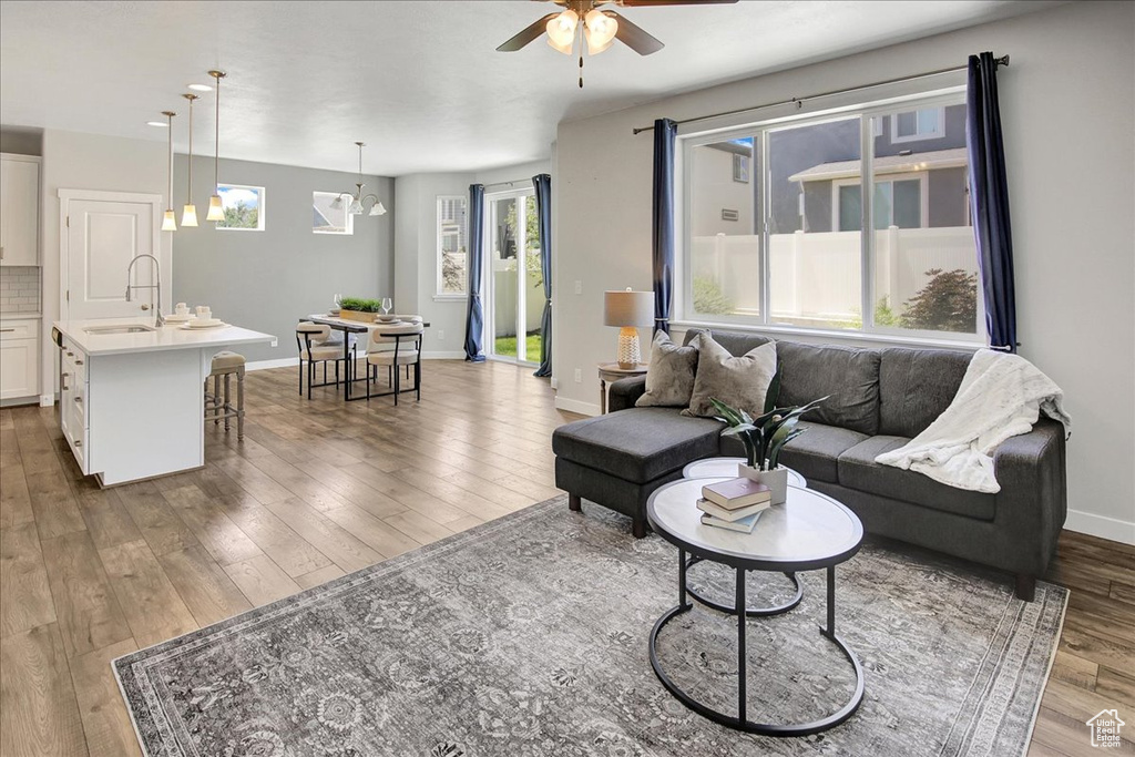 Living area with a ceiling fan and wood finished floors