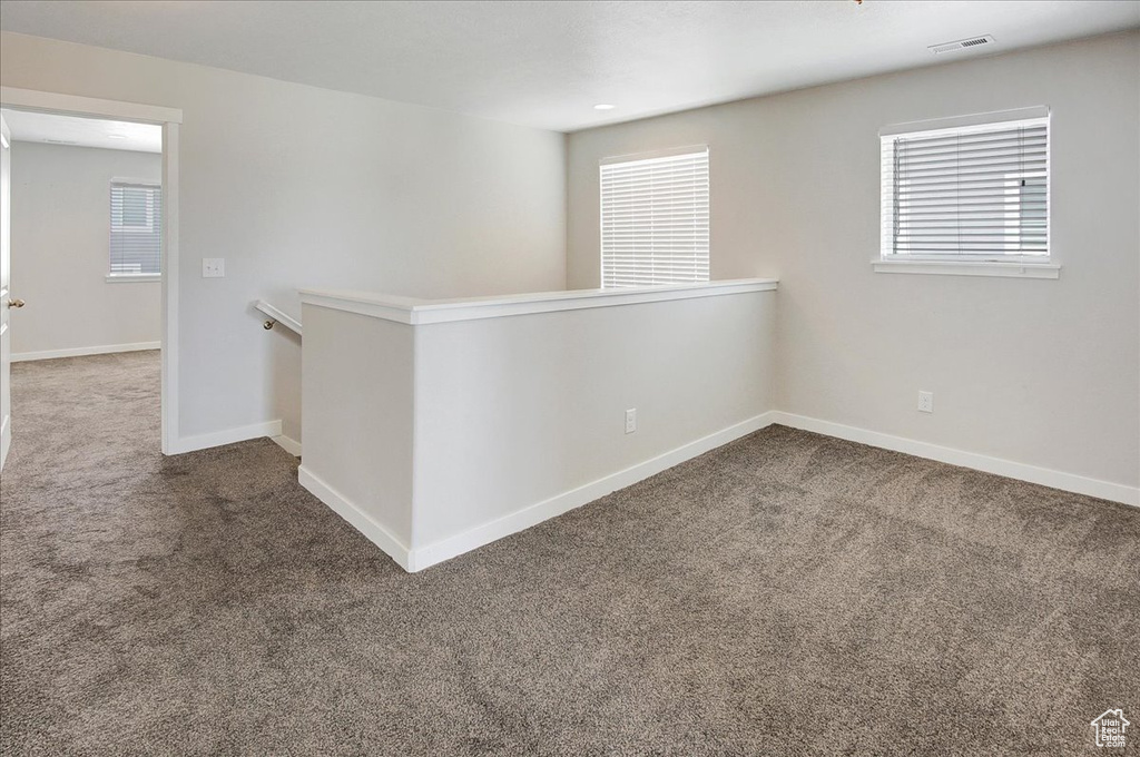 Carpeted empty room with plenty of natural light