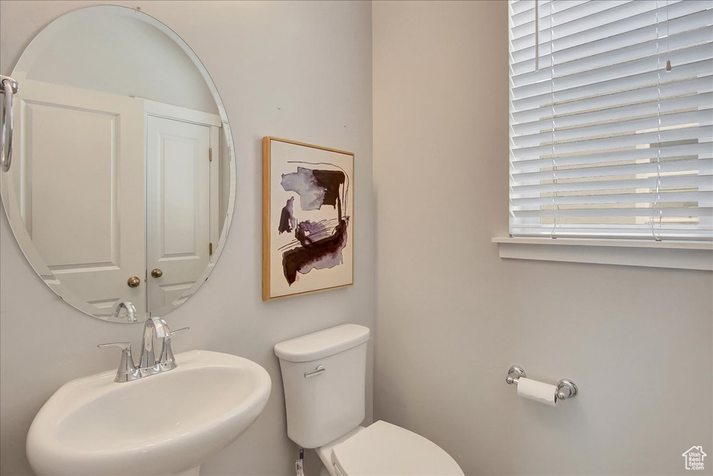 Half bath with a sink and toilet