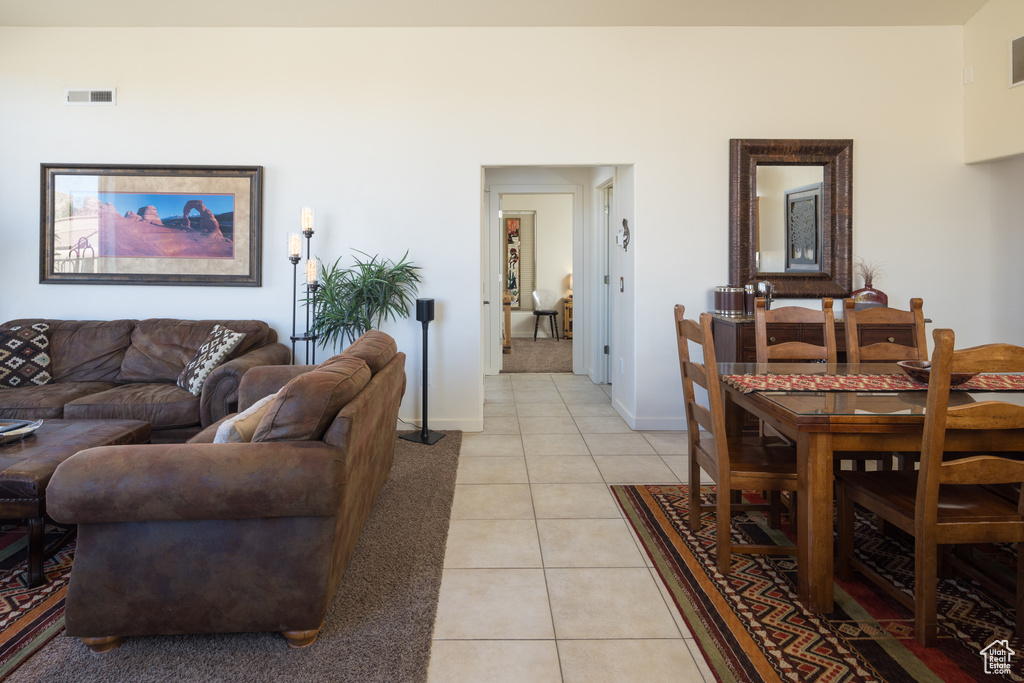 Living room featuring light tile patterned flooring and light colored carpet
