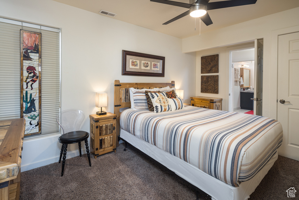 Carpeted bedroom featuring a ceiling fan