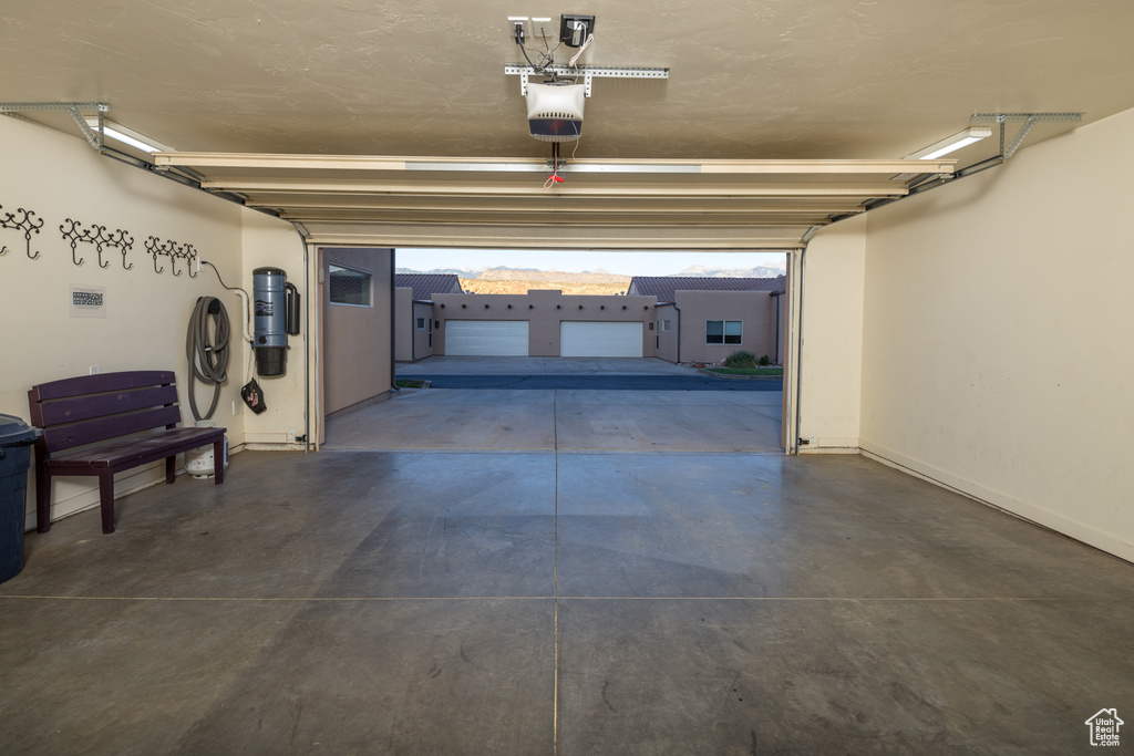 Garage with a garage door opener and a central vacuum unit