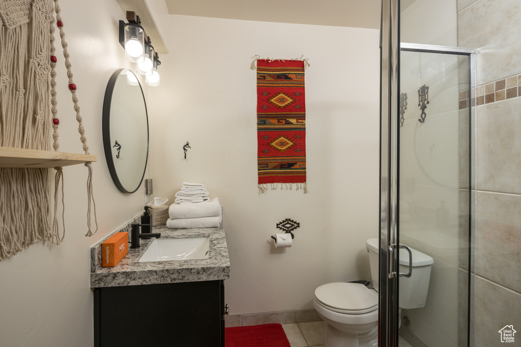 Bathroom with vanity, tile patterned flooring, and a shower stall