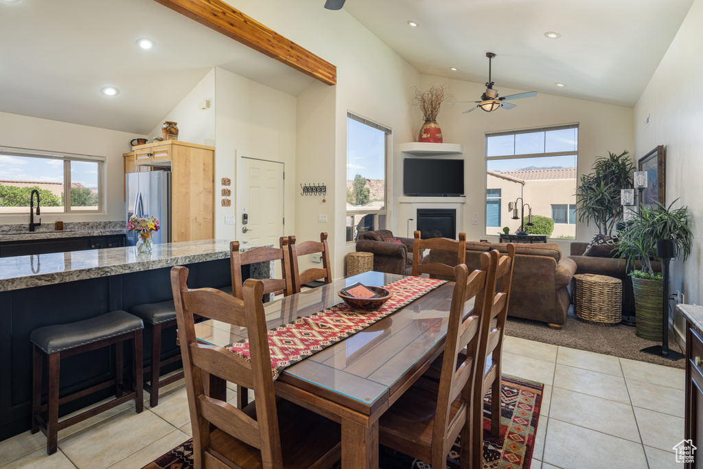 Dining room with a ceiling fan, lofted ceiling, recessed lighting, and light tile patterned floors