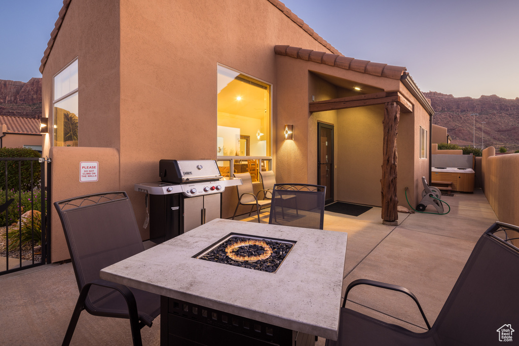 View of patio featuring an outdoor fire pit and area for grilling