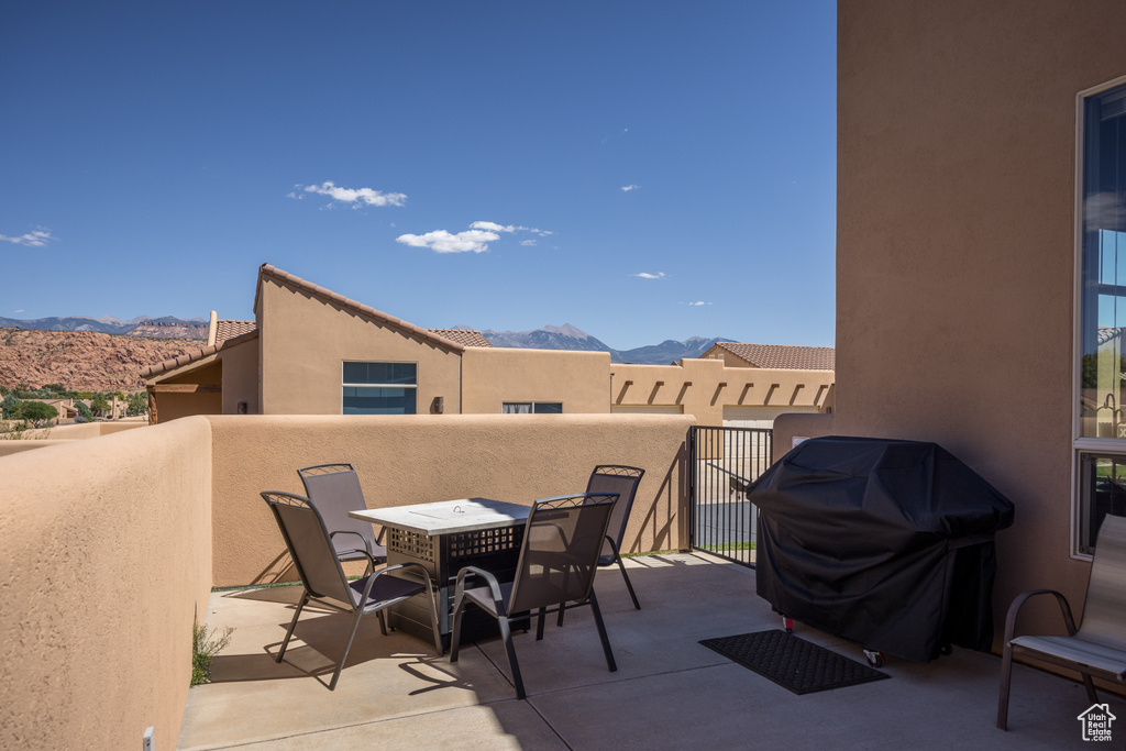 Patio / terrace featuring a mountain view, grilling area, and outdoor dining space