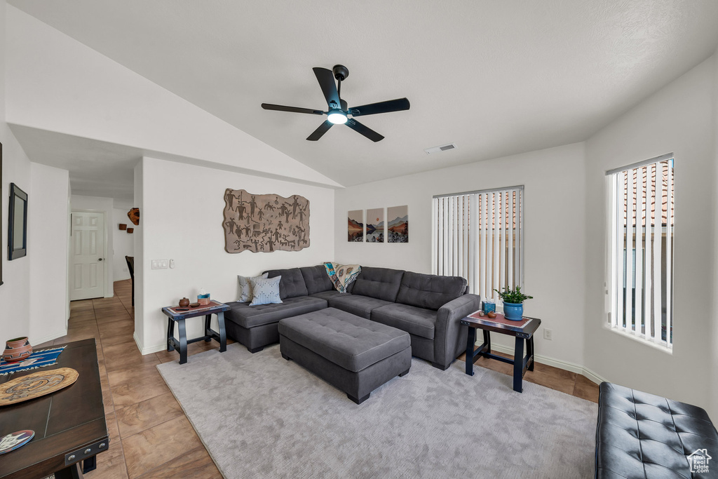 Living area with a ceiling fan and vaulted ceiling