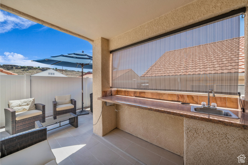 View of patio with a sink and exterior kitchen