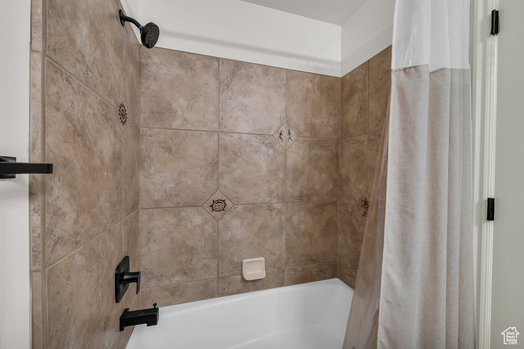 Bathroom featuring shower / bath combination with curtain