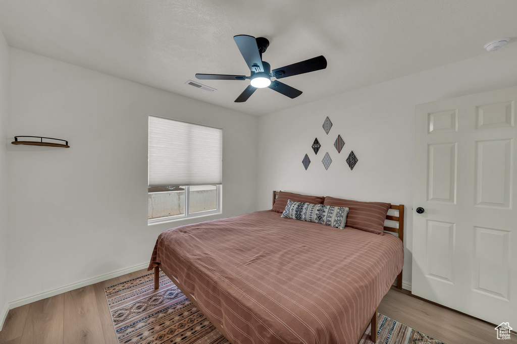Bedroom featuring wood finished floors and a ceiling fan
