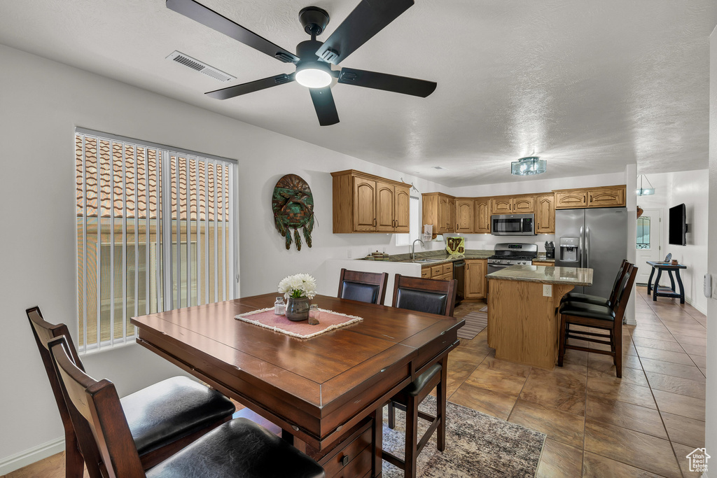 Dining space with a ceiling fan