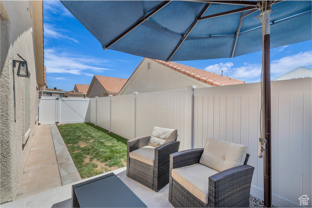 Fenced backyard with a gate and a patio