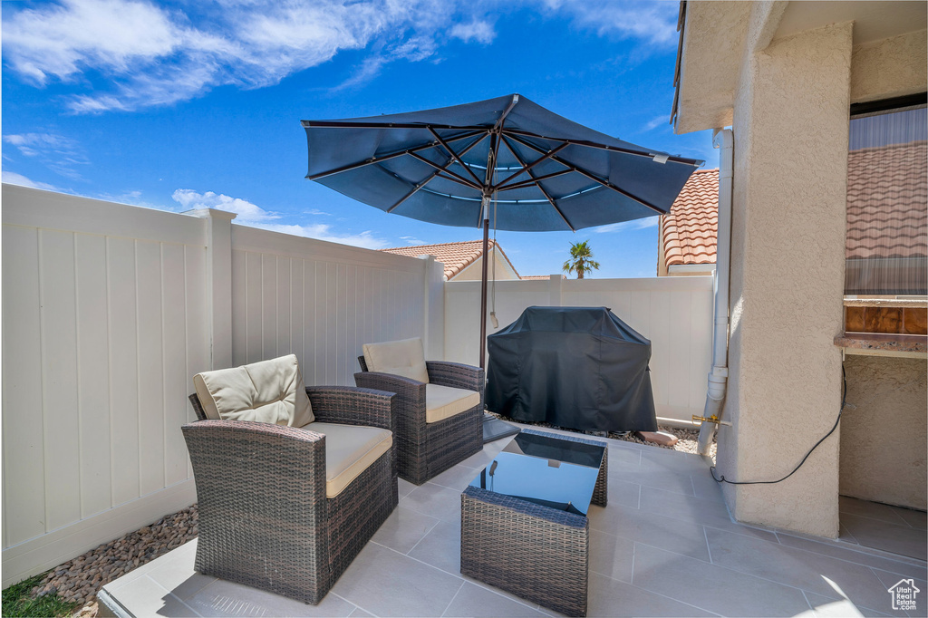 Fenced backyard with area for grilling, a patio, and an outdoor hangout area