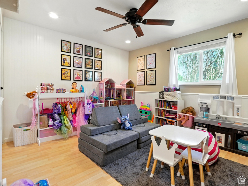 Recreation room with wood finished floors, a ceiling fan, and recessed lighting