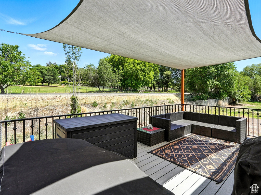 Wooden deck with an outdoor hangout area and view of scattered trees
