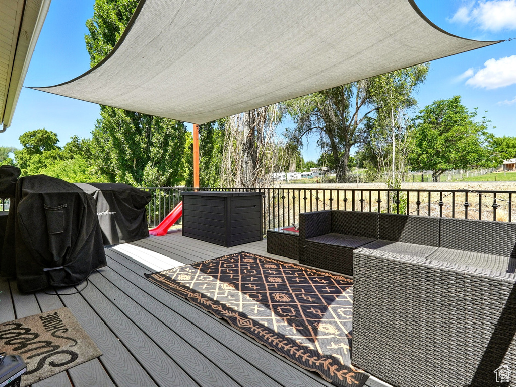 Deck with outdoor lounge area and a grill