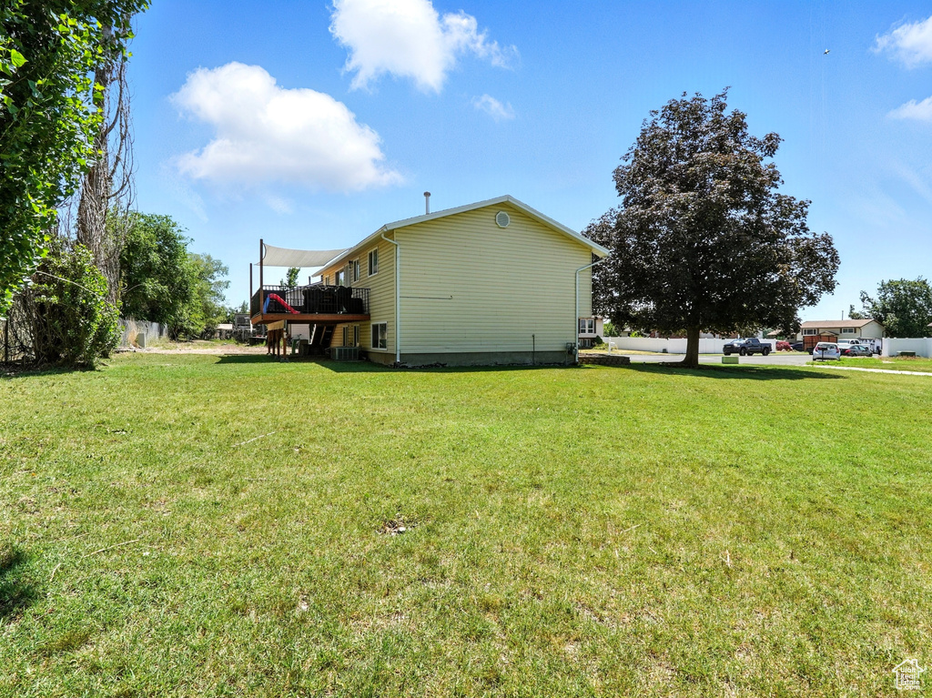 View of home's exterior featuring a yard and a deck