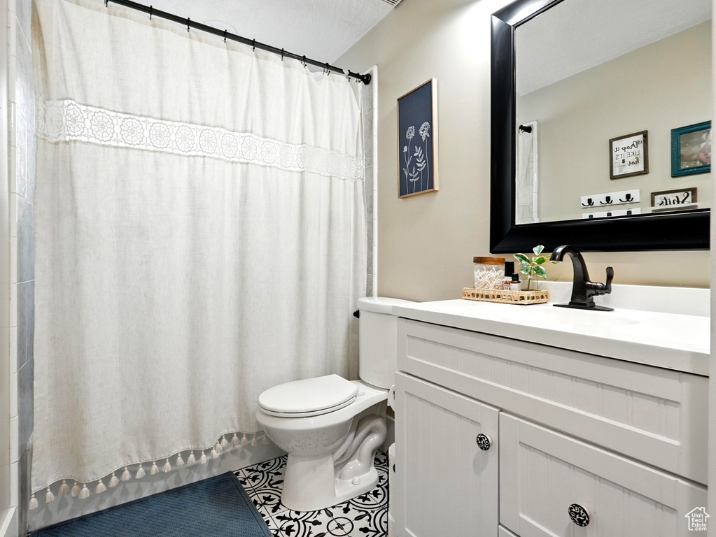 Full bathroom with vanity, tile patterned floors, and shower / tub combo