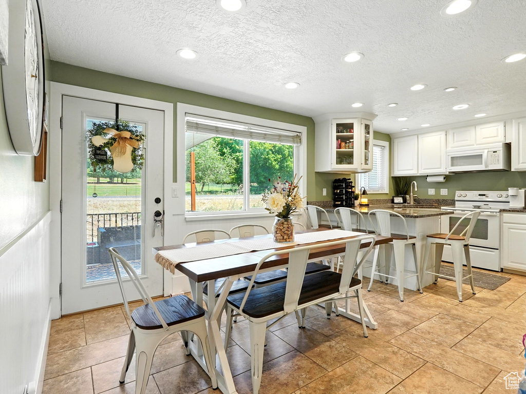 Dining room with a textured ceiling and recessed lighting