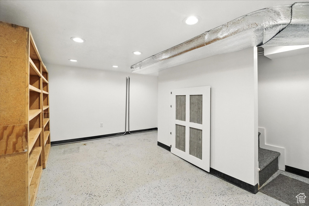 Spare room with recessed lighting and finished concrete floors