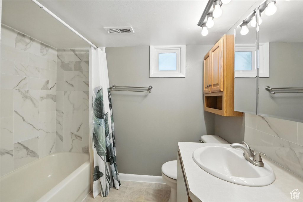 Bathroom featuring vanity and shower / tub combo