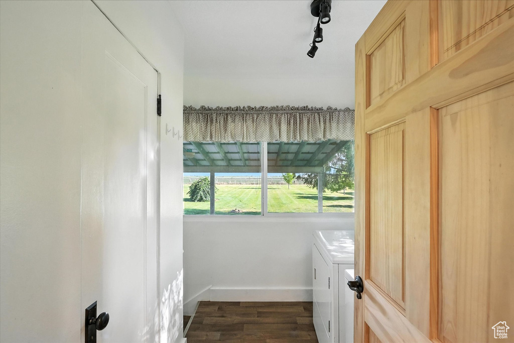 Laundry room featuring independent washer and dryer and dark wood finished floors