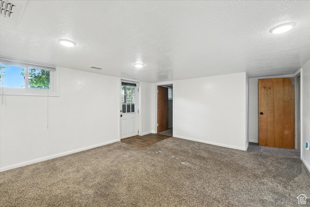 Spare room with a textured ceiling and carpet flooring