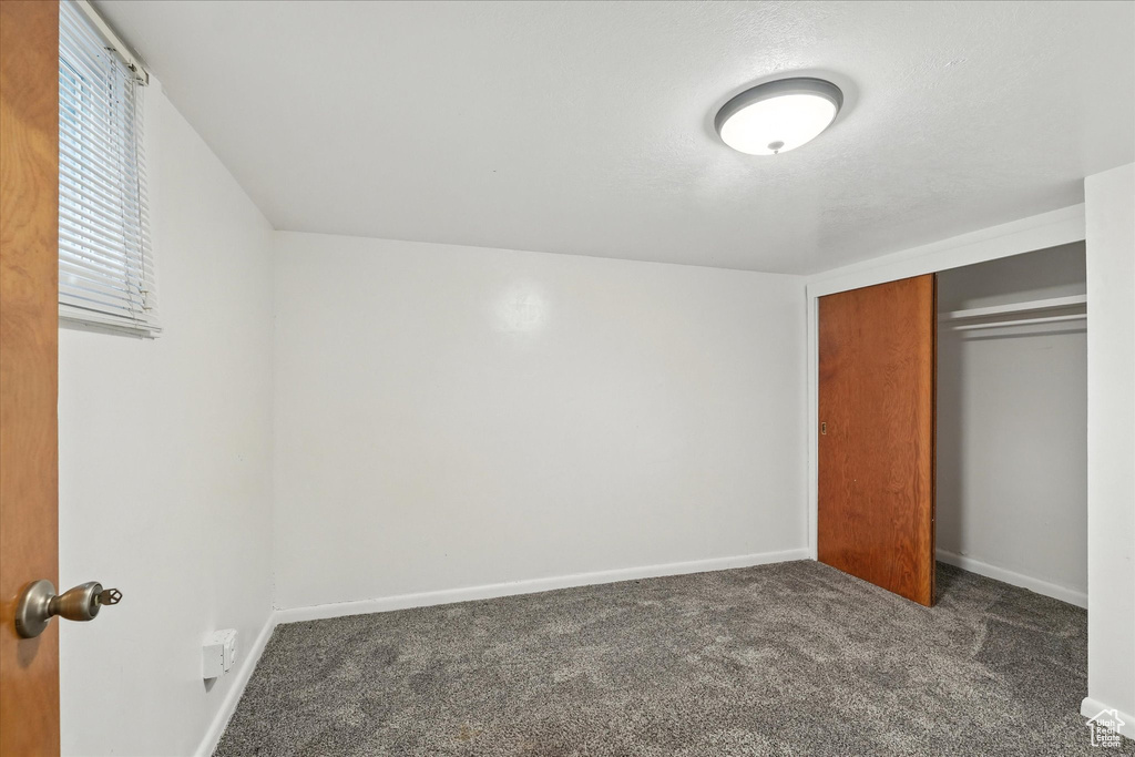 Unfurnished bedroom with carpet floors and a closet
