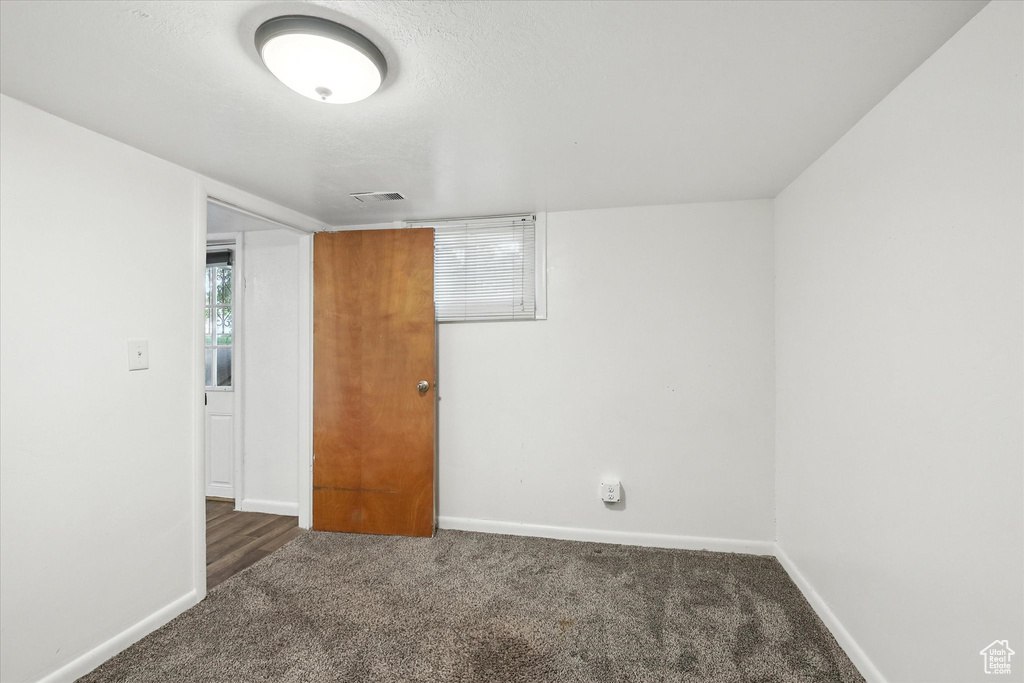 Spare room featuring carpet floors and baseboards
