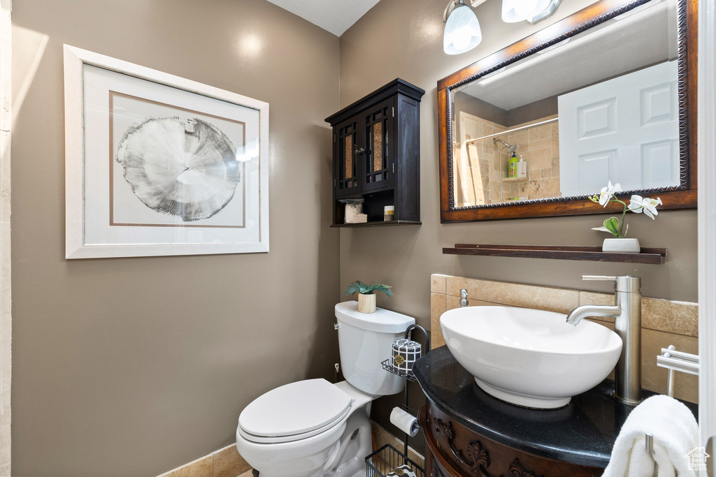 Bathroom featuring a shower with shower curtain and vanity