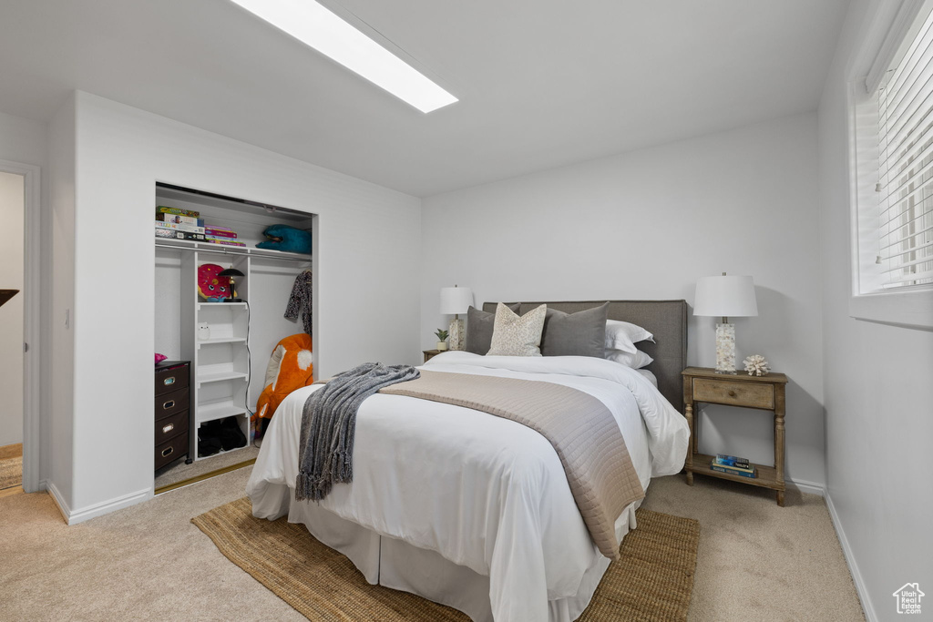 Bedroom with carpet and a closet
