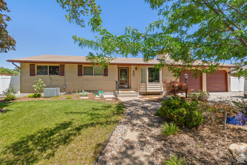 Ranch-style home with an attached garage, brick siding, and concrete driveway