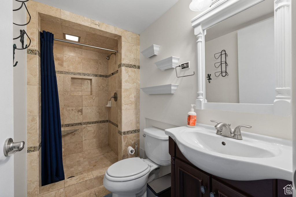 Bathroom featuring vanity and tiled shower