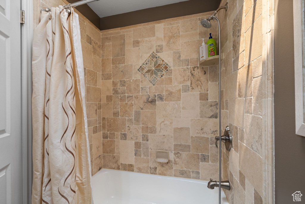 Bathroom featuring shower / tub combo with curtain