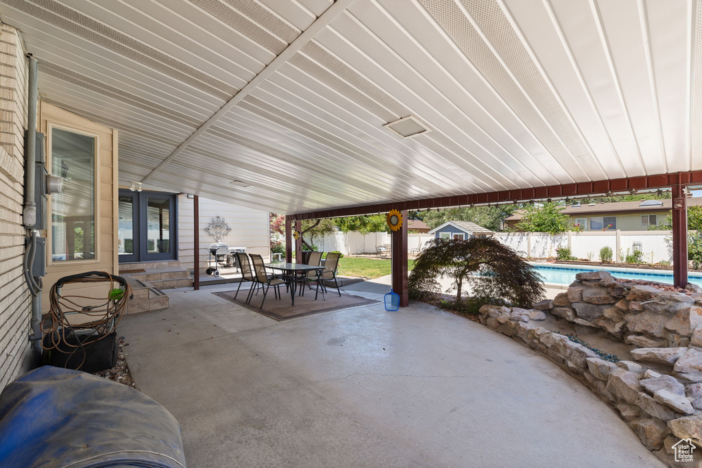Fenced backyard featuring outdoor dining space and a patio