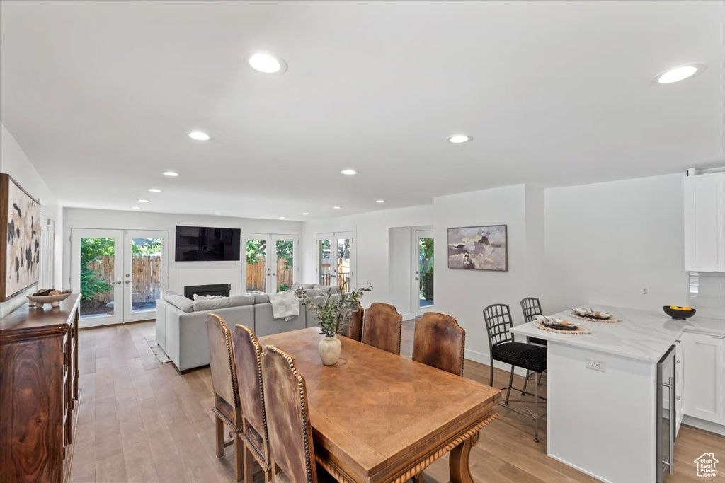 Dining space with light wood-type flooring, recessed lighting, and french doors