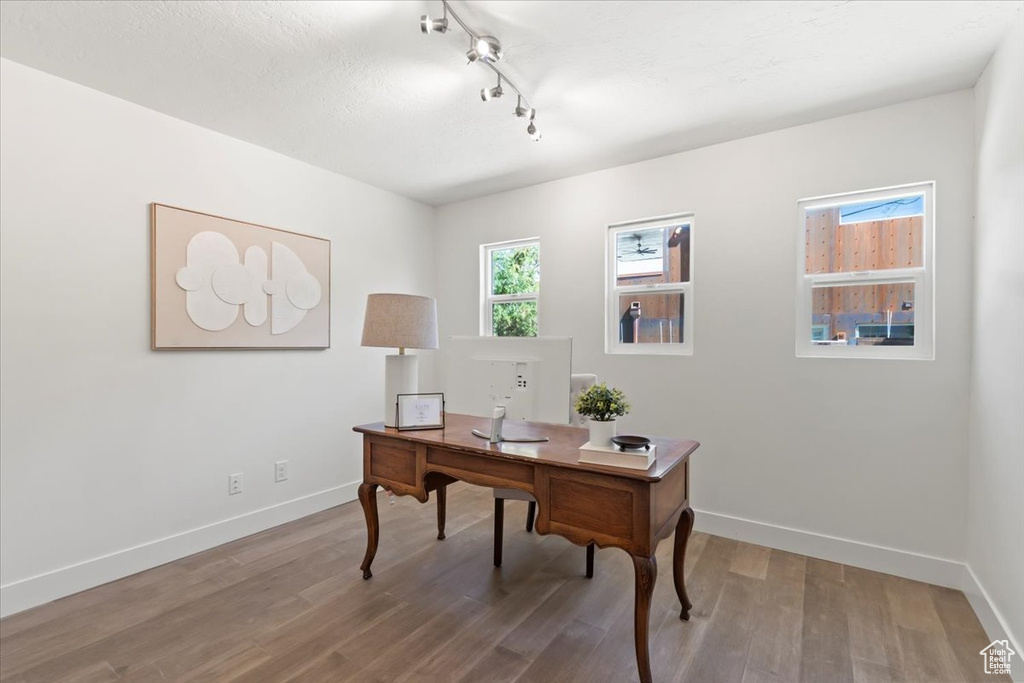 Office area featuring wood finished floors and track lighting