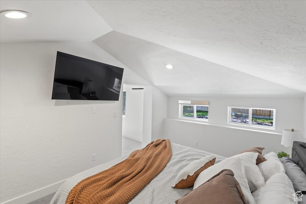 Bedroom featuring lofted ceiling, recessed lighting, and carpet