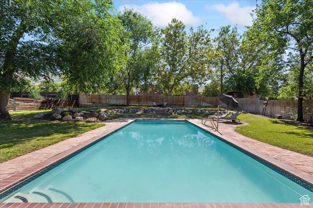 View of pool featuring a patio and a fenced backyard