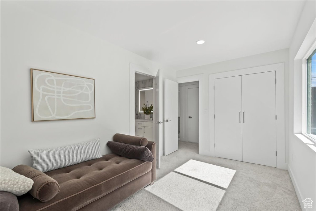 Living area featuring light carpet and recessed lighting