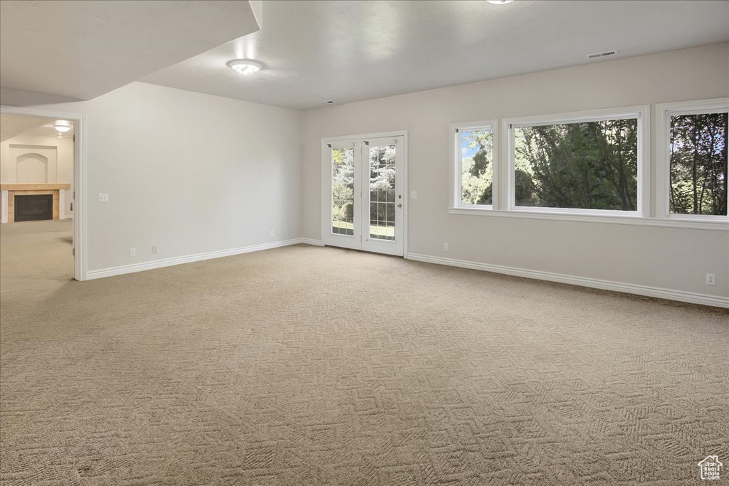 Carpeted empty room featuring baseboards