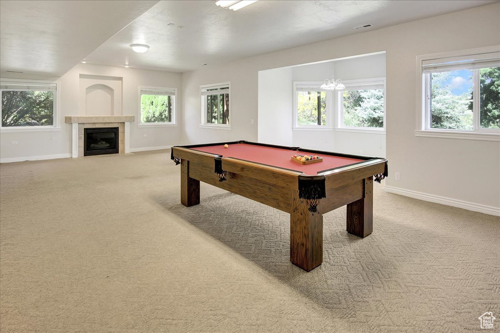 Playroom with carpet flooring, billiards table, and a tiled fireplace