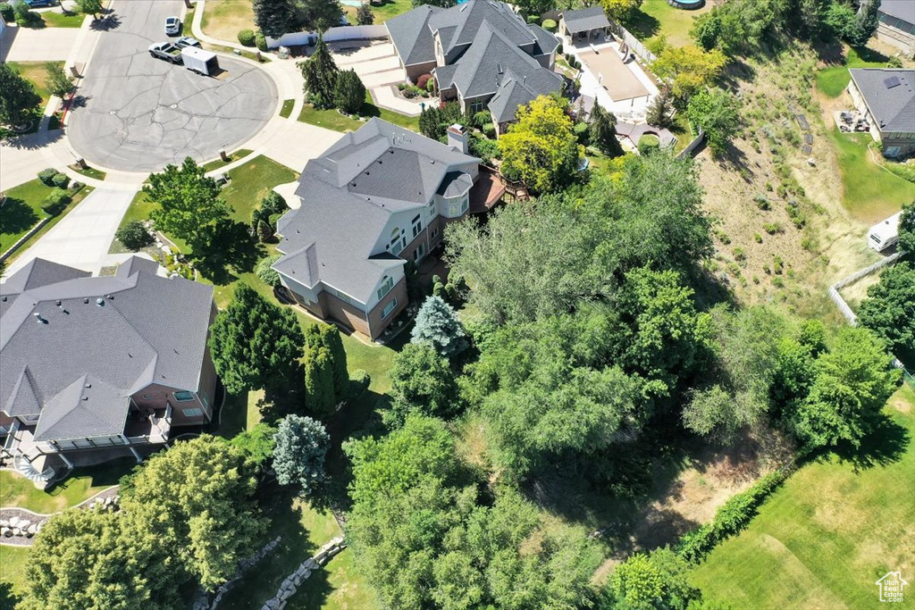 Aerial view of property and surrounding area featuring nearby suburban area