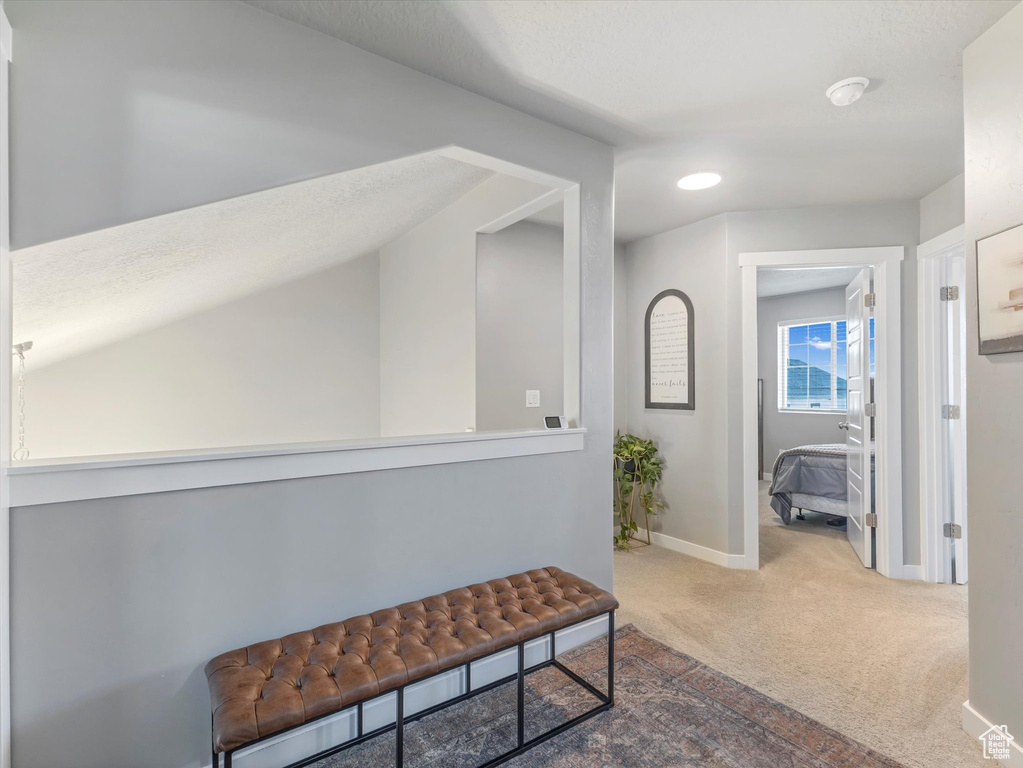 Hall featuring carpet flooring and baseboards