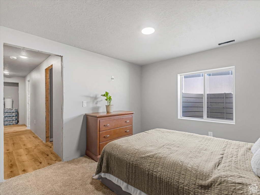 Bedroom featuring light colored carpet