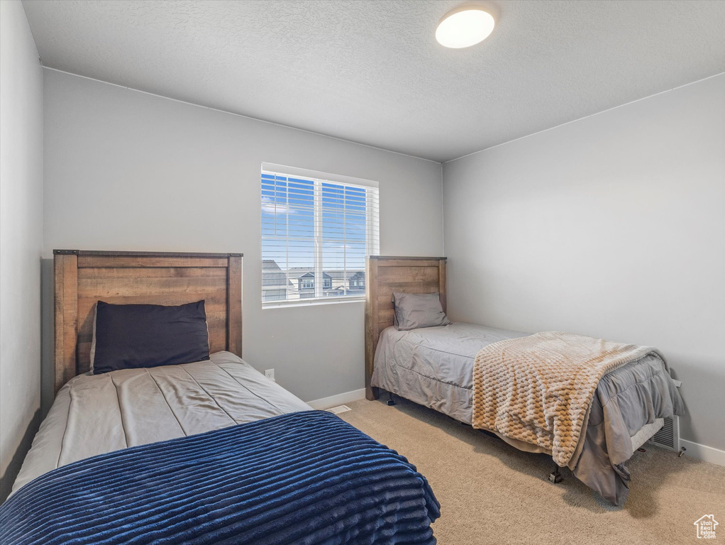 Bedroom with carpet floors and a textured ceiling